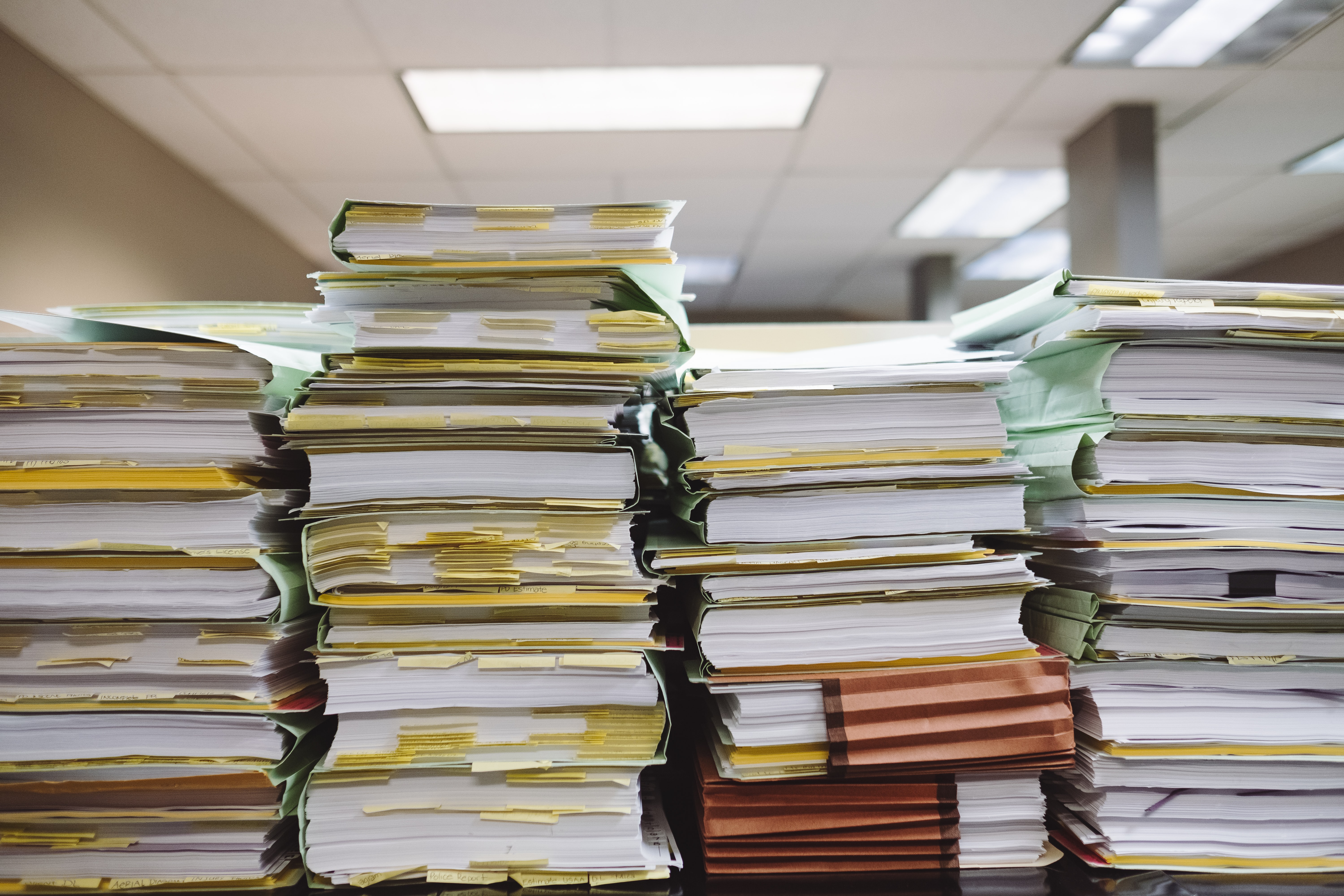 image showing piles of paper and files to support content about converting paper forms to digital for a more sustainable independent school