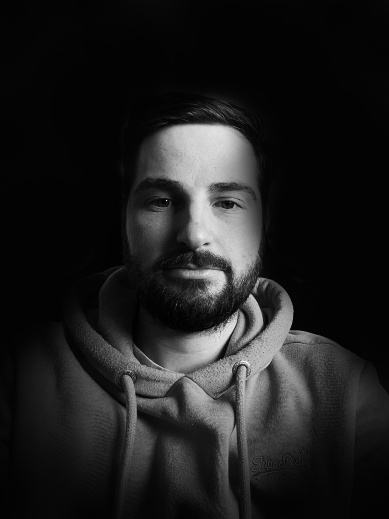 headshot of website developer Tom in black and white